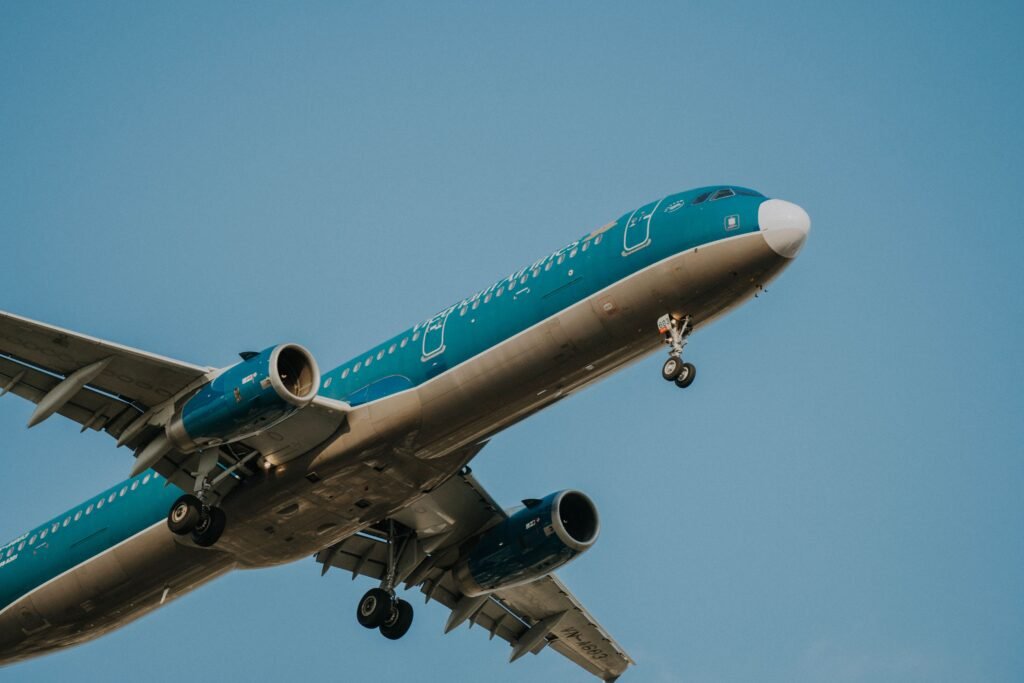 A Vietnam Airlines passenger airplane in flight, clear blue sky backdrop.